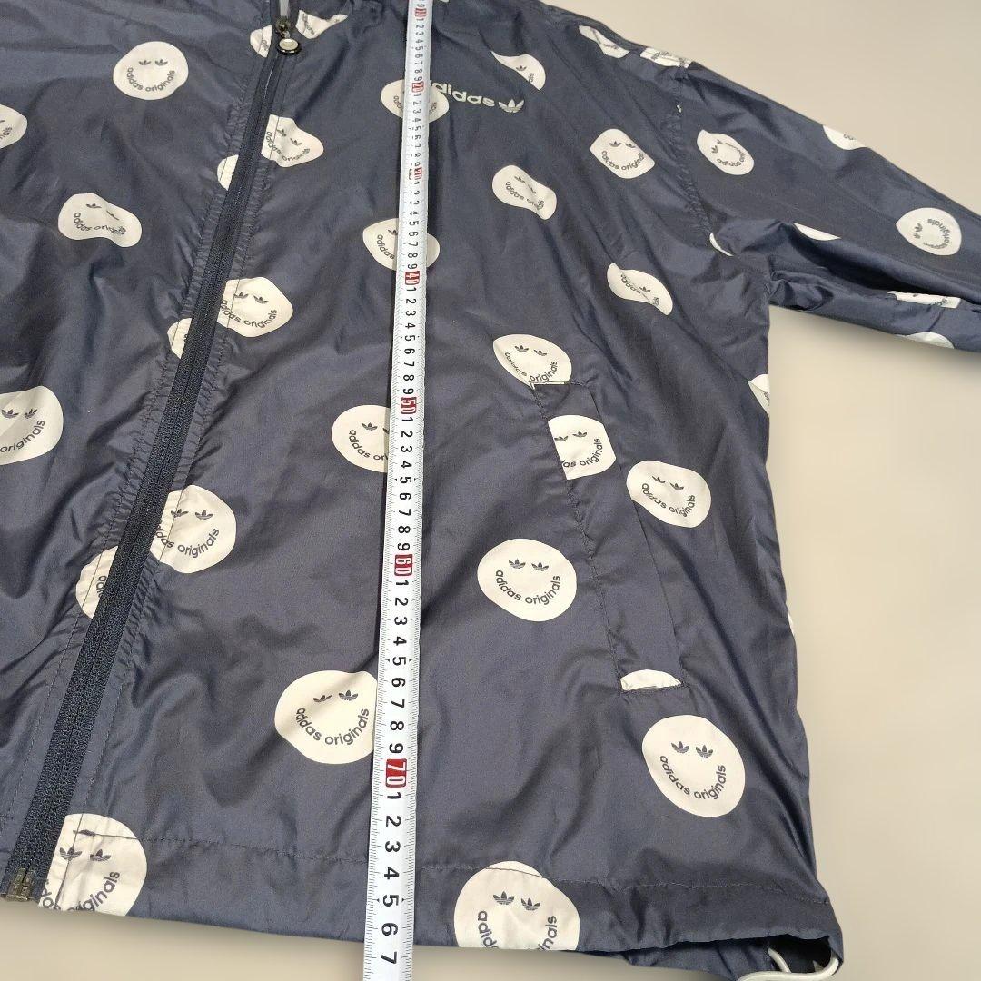 アディダスadidasプリントウィンドブレーカースマイリーフェイス