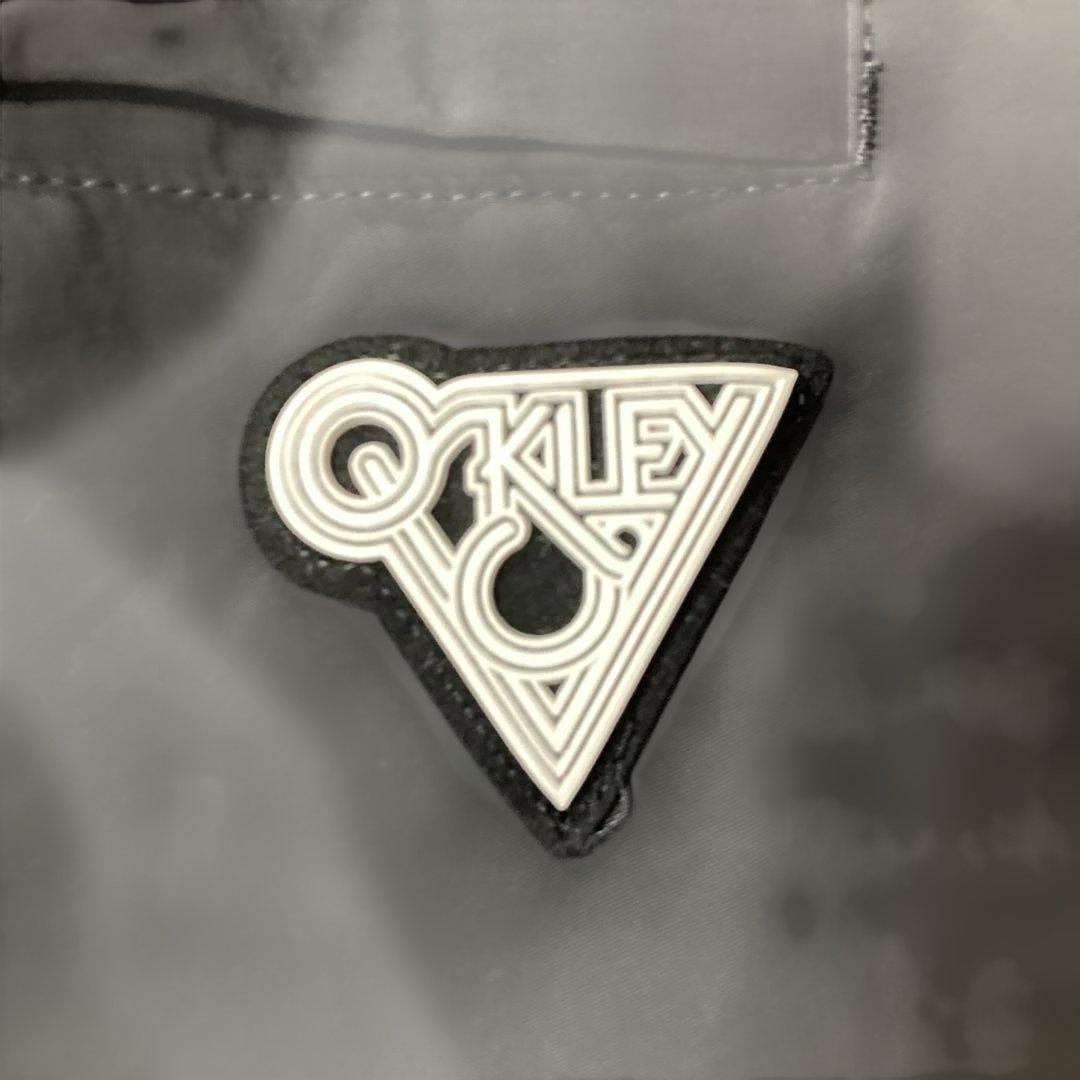 新品未使用タグ付きOAKLEYマットチャコールグレーピステウィンドブレーカーXL